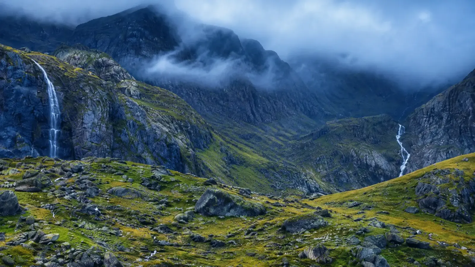 Misty mountain waterfall landscape in Scotland